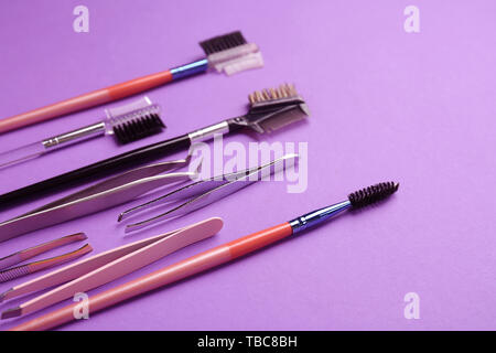 Set of tools for eyebrows correction on color background Stock Photo