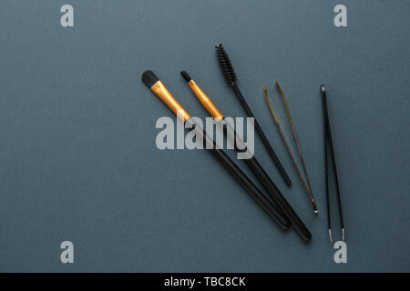 Set of tools for eyebrows correction on grey background Stock Photo