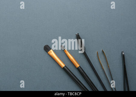 Set of tools for eyebrows correction on grey background Stock Photo