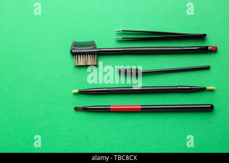 Set of tools for eyebrows correction on color background Stock Photo