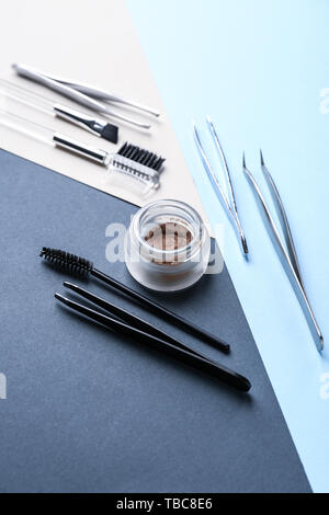 Set of tools for eyebrows correction on color background Stock Photo