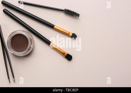 Set of tools for eyebrows correction on color background Stock Photo