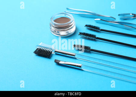 Set of tools for eyebrows correction on color background Stock Photo