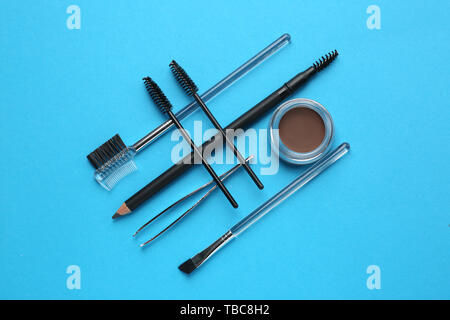 Set of tools for eyebrows correction on color background Stock Photo