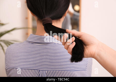 Woman holding hair of young girl. Concept of donation Stock Photo