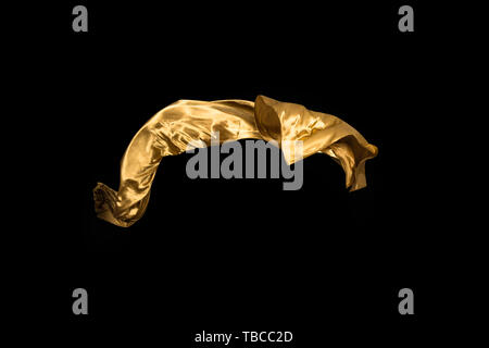 golden soft satin flying in wind on background Stock Photo