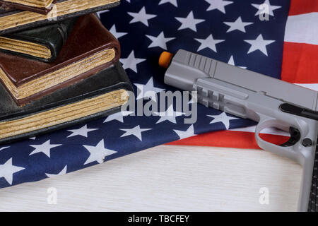 School shooting gun american firearm handgun lying on US flag Stock Photo