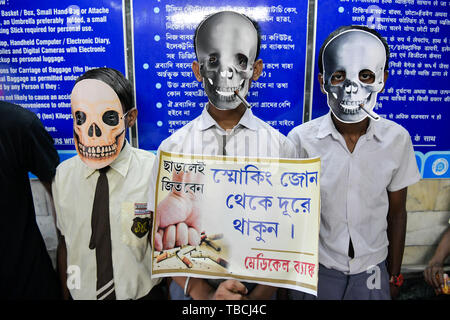 School students wear skeleton masks as they participate in an anti-smoking campaign during the World No Tobacco Day in Kolkata. Stock Photo