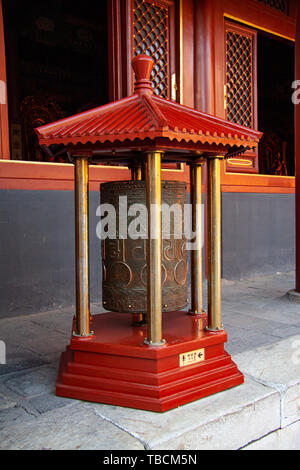 Prayer wheel inside The Lama Temple Yonghegong in Beijing, China. Buddhists turn prayer wheels in a clockwise direction. Stock Photo