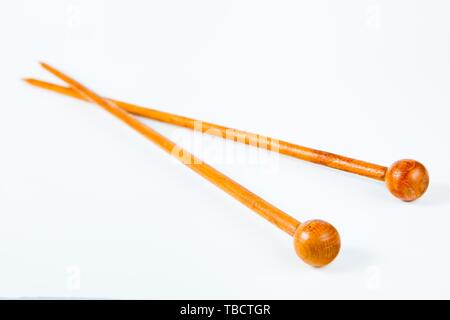 Pair of wooden knitting needles with safety balls and the ends Stock Photo