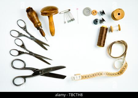 Vintage tailor's tools set, old instrument for hand made tailoring, copy space at the middle Stock Photo