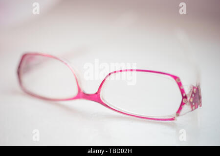 glasses with violet rim lie on a white table, closeup Stock Photo