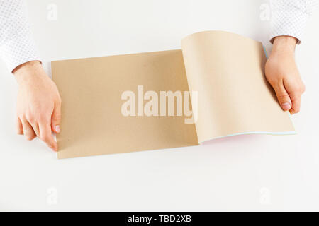Hand holding blank opened book mock up Stock Photo