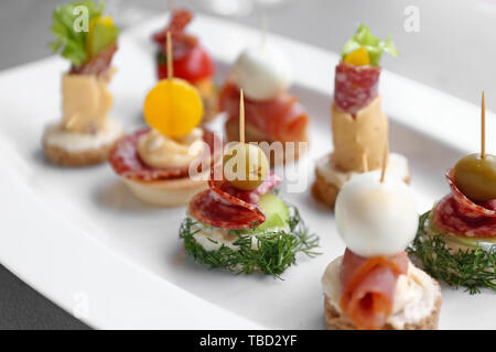 Tasty canapes on plate, closeup Stock Photo