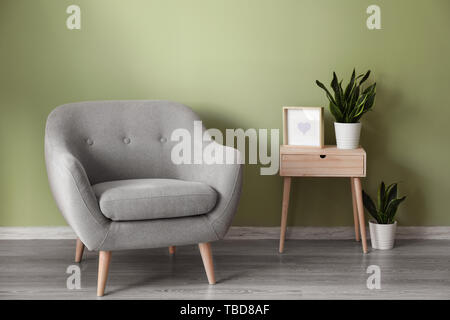 Soft Armchair With Table Near Color Wall In Living Room Stock Photo Alamy