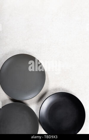 Empty Black and Grey Plates on Grey Background, Top View, Copy Space Stock Photo