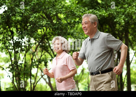 An elderly couple working out in a park Stock Photo
