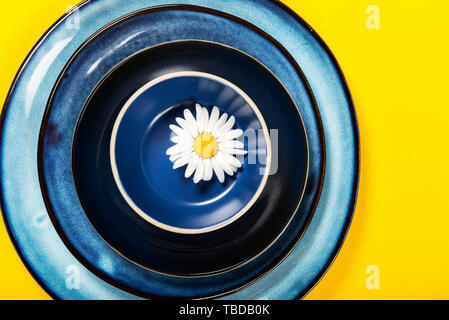 Empty Blue Plates on Bright Yellow Background, Top View, Copy Space Stock Photo
