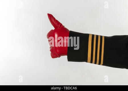 Four gold stripes on a uniform jacket with hands wearing red gloves signal thumbs up Stock Photo