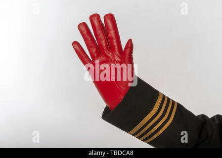 Four gold stripes on a uniform jacket with hands wearing red gloves and waving Stock Photo