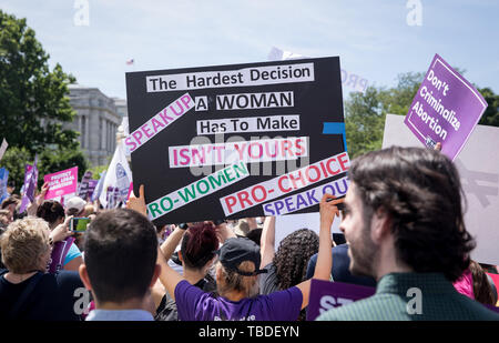 Woman rights activists rally in support of pro-choice and keeping abortion legal outside the Supreme Court May 21, 2019 in Washington, DC. The protest was part of the national call to action following new state laws banning legal abortion in Republican states. Stock Photo