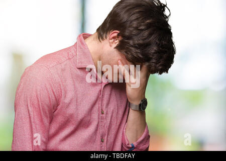 Young handsome business man over isolated background with sad expression covering face with hands while crying. Depression concept. Stock Photo