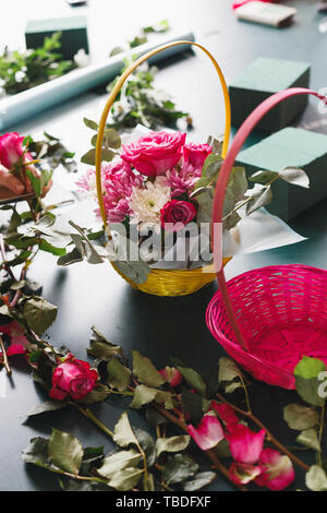 Master class of female florist at work with bunch of flowers. Girl making bouquet of various autumn flowers. Business woman florist at flower shop Stock Photo