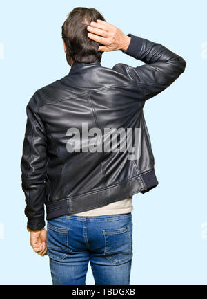Middle age handsome man wearing black leather jacket Backwards