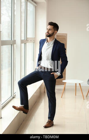 Fashionable young man near window Stock Photo