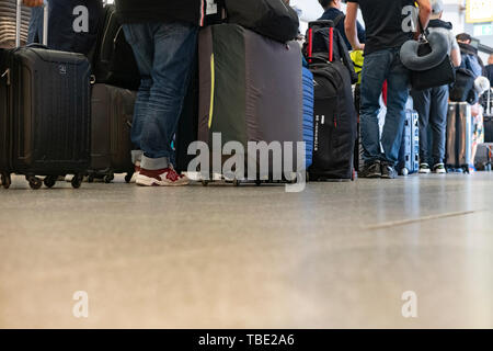 Berlin, Germany. 24th May, 2019. Travellers stand at a gate at Tegel Airport and wait for check-in. Credit: Paul Zinken/dpa/Alamy Live News
