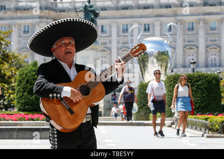 Madrid, Spain. 01st June, 2019. A man plays the Spanish Guitar in front of the giant Champions League trophy at the Royal Palace prior to the UEFA Champions League Final match between Tottenham Hotspur and Liverpool at Wanda Metropolitano on June 1st 2019 in Madrid, Spain. (Photo by Daniel Chesterton/phcimages.com) Credit: PHC Images/Alamy Live News Credit: PHC Images/Alamy Live News