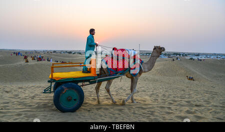 Jaisalmer, India - Nov 8, 2017. Riding camel on Thar Desert in Jaisalmer, India. Thar Desert is a large arid region in the northwestern part of the In Stock Photo