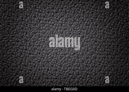 Perforated black leather texture background with gradient frame, closeup. Gray backdrop from wrinkle skin, structure of textile with vignette. Stock Photo