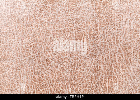 Light brown background from a soft upholstery textile material, closeup. Matte velvet fabric with natural texture. Cloth backdrop. Stock Photo