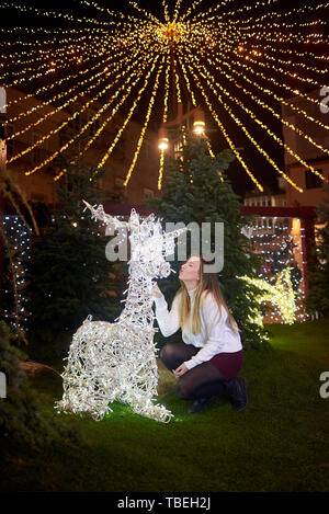 Young woman enjoying the Christmas decoration in Vigo, Galicia, Spain Stock Photo