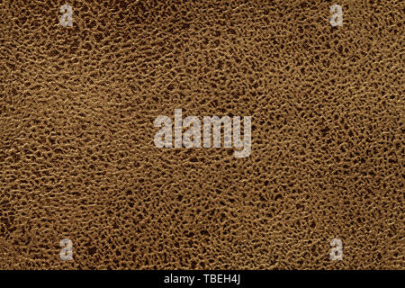 Dark brown background from a soft upholstery textile material, closeup. Matte bronze velvet fabric with natural texture. Cloth backdrop. Stock Photo