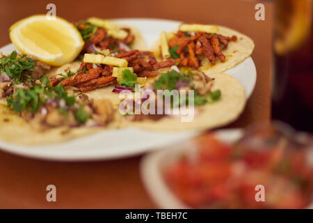 Mexican Tacos 'Pastor' and 'Carnitas' with pork and beef in yellow tortilla Stock Photo