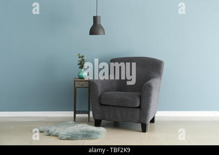 Soft Armchair With Table Near Color Wall In Living Room Stock Photo Alamy