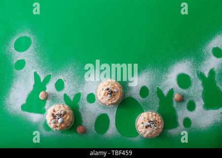 Tasty Easter cupcakes on color background Stock Photo