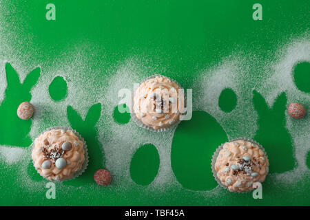 Tasty Easter cupcakes on color background Stock Photo