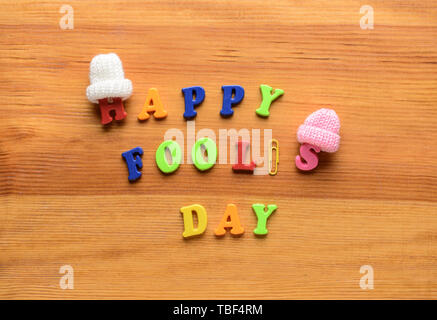 Phrase HAPPY FOOL'S DAY on wooden background Stock Photo