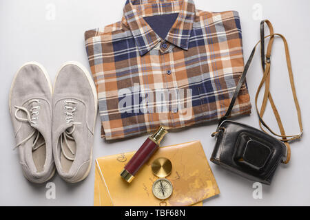 Male clothes with travel objects on light background Stock Photo