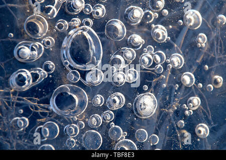 Texture abstract closeup background ice with bubbles of air caught by frost in the mass of water while freezing. Stock Photo