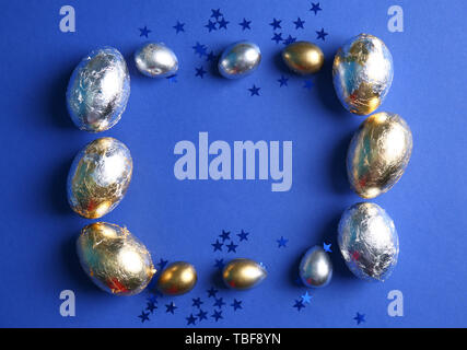 Frame made of Easter eggs on color background Stock Photo