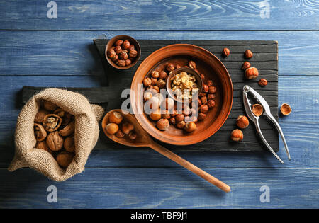 Different tasty nuts on wooden table Stock Photo