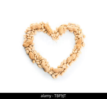 Heart-shaped frame made of tasty peanuts on white background Stock Photo