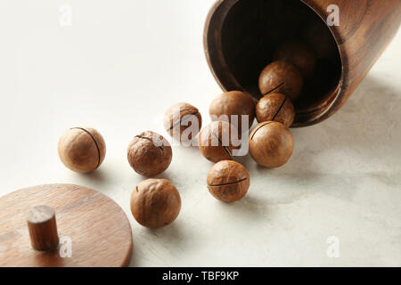 Tasty macadamia nuts on light background Stock Photo