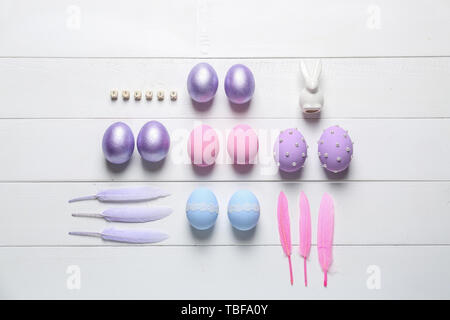 Easter composition with painted eggs on white wooden background Stock Photo