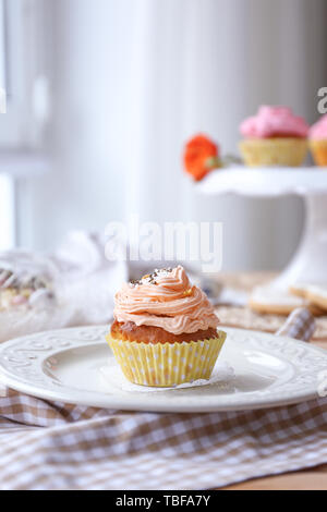 Tasty Easter cupcake on plate Stock Photo