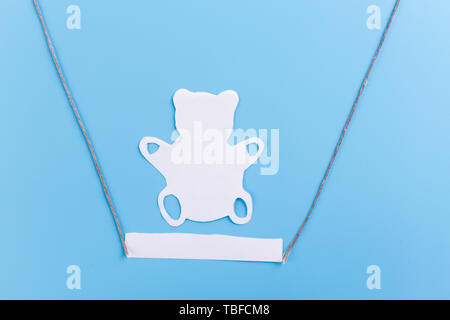 Lonely forgotten abandoned teddy bear on swing Stock Photo